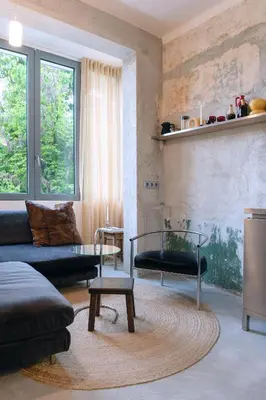 a living room with a couch and a table at Dazzling Minimalist One Bedroom Apartment in Sofia