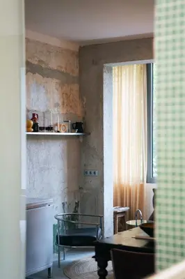 a living room with a table and a window at Dazzling Minimalist One Bedroom Apartment in Sofia