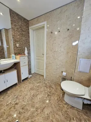 a bathroom with a toilet and a sink and a mirror at Alex Place-Central Sofia in Sofia