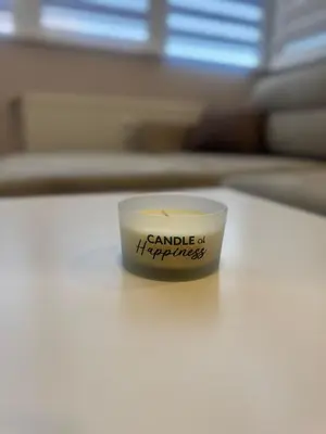 a small cup with the words candleciplinary happiness on it at West Park Apartment in Sofia