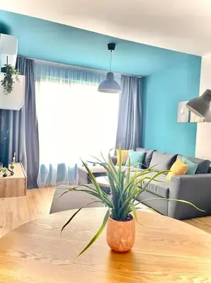 a living room with a potted plant on a table at Luxurious apartment 1BDR by Top Kvartiri Ltd in Sofia