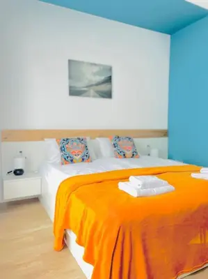 a bedroom with a bed with an orange blanket at Luxurious apartment 1BDR by Top Kvartiri Ltd in Sofia