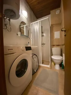 a washing machine in a bathroom with a toilet at Cozy flat in NEON in Bansko