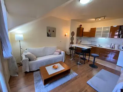 a living room with a couch and a table at Cozy flat in NEON in Bansko
