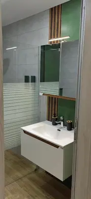 a bathroom with a white sink and a mirror at Apartmenthaus Oborishte - 31 in Panagyurishte