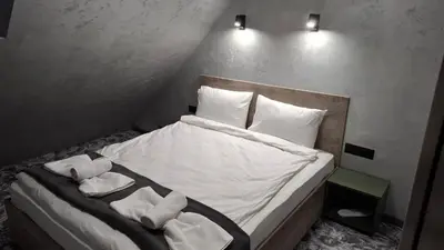 a bedroom with a bed with towels on it at RCR Einstein studios 2 in Sofia