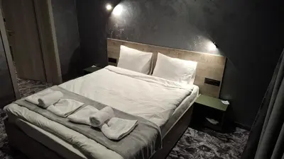 a bedroom with a bed with towels on it at RCR Einstein studios 2 in Sofia