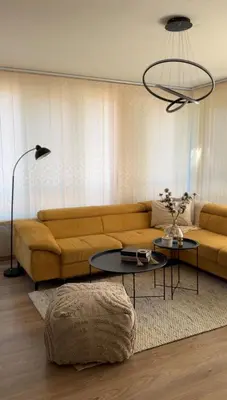 a living room with a couch and a table at Славянска резиденс - Спокойствие в центъра на Пловдив in Plovdiv