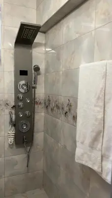 a bathroom with a shower with a towel at Славянска резиденс - Спокойствие в центъра на Пловдив in Plovdiv