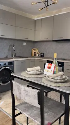 a kitchen with a table with napkins and a bottle of wine at Славянска резиденс - Спокойствие в центъра на Пловдив in Plovdiv
