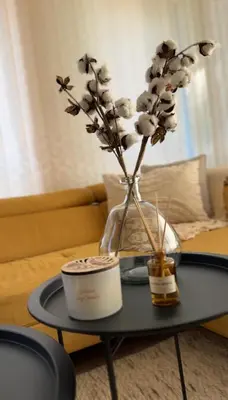 a vase with flowers in it on a table at Славянска резиденс - Спокойствие в центъра на Пловдив in Plovdiv
