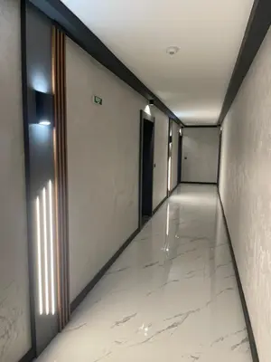 an empty hallway with white marble floors and a door at Modern 1BR Apart FREE Parking with Hill View in Plovdiv