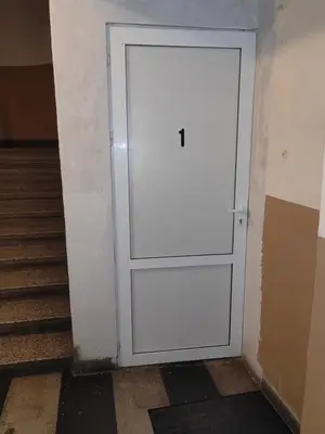 a white door in a hallway with stairs at Graf Ignatiev 27 in Sofia