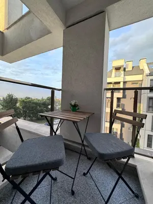 a balcony with two chairs and a table on a balcony at Studio AUREA in Sofia