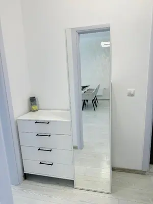 a white dresser and a mirror in a room at Danielis Apartament in Velingrad