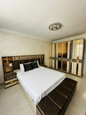 a bedroom with a large bed with a large white bedspread at Danielis Apartament in Velingrad