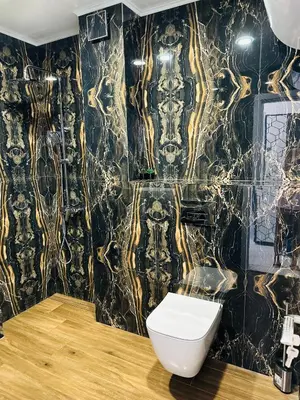 a bathroom with a black and gold wallpaper at Danielis Apartament in Velingrad