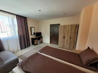 a living room with a bed and a couch at Къща за гости ЕВА in Madzhare