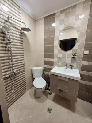 a bathroom with a toilet and a sink and a shower at Къща за гости ЕВА in Madzhare