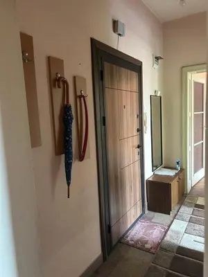 a hallway with a door and an umbrella on the wall at Apartment11in the center of Sofia in Sofia