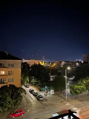 a city at night with cars parked in a parking lot at Apartment11in the center of Sofia in Sofia