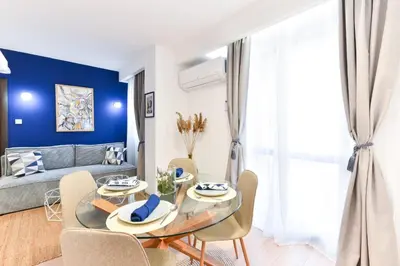 a living room with a glass table and chairs at Lyana's One Bedroom apartment in Bansko