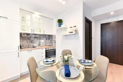 a dining room with a glass table and chairs at Lyana's One Bedroom apartment in Bansko