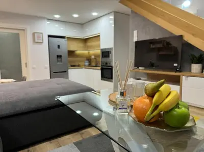 a glass table with a plate of fruit on it in a kitchen at Modern Vitosha Maisonette with Garage in Sofia