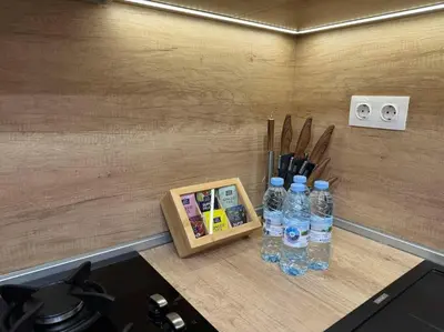 a counter with bottles of water and a knife block at Modern Vitosha Maisonette with Garage in Sofia