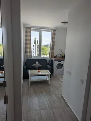 a living room with a couch and a table at Reina Apartment- next to Sofia zoo and close to Mall Paradise in Sofia