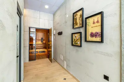 a hallway with three pictures on the wall at Парк Хотел Модър in Devin