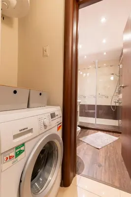 a washing machine in a bathroom with a shower at My Place in Sofia