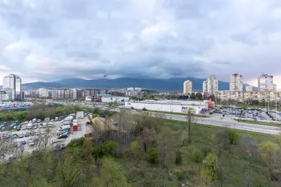 a city with cars parked in a parking lot at My Place in Sofia
