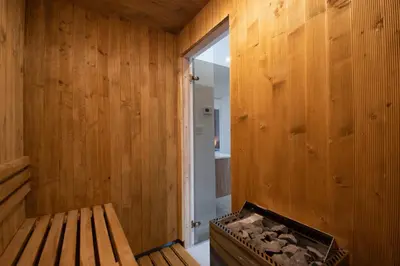 an empty room with a tub in a wooden room at Hyggemate - Nordic Villa with Sauna & Jacuzzi Retreat in Sarnitsa