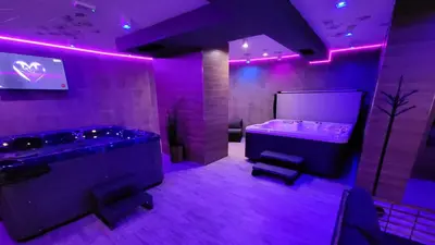a purple room with a tub and a sink at The Bear Pamporovo in Pamporovo
