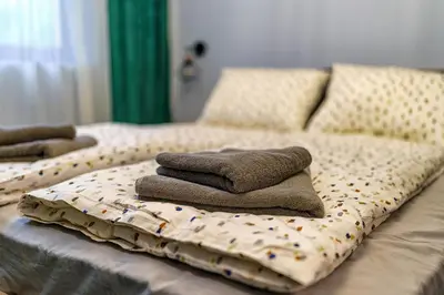 a bed with three pillows on top of it at Mursala Pamporovo in Pamporovo