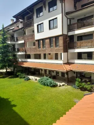 an apartment building with a lawn in front of it at Lux apartment 223 in Bansko
