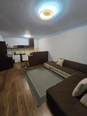 a living room with a couch and a table at Lux apartment 223 in Bansko