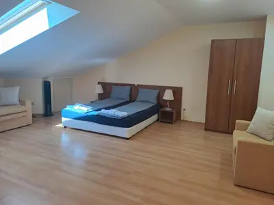 a bedroom with a blue bed and a couch at Family Studio 407, Villa park in Borovets