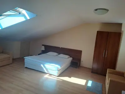 a bedroom with a bed and a skylight at Family Studio 407, Villa park in Borovets