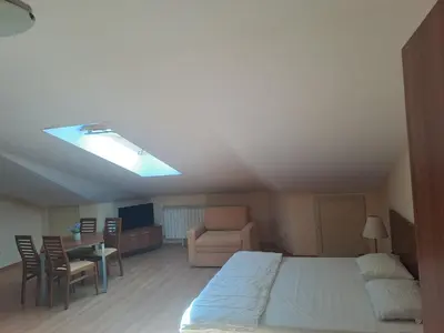 a bedroom with a bed and a table and a chair at Family Studio 407, Villa park in Borovets