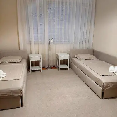 a bedroom with two beds and a window at La Casa di Sofia in Sofia