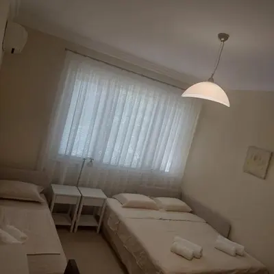 a bedroom with two beds and a large window at La Casa di Sofia in Sofia