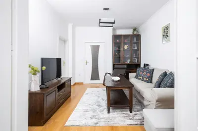 a living room with a couch and a tv at 1BD flat with Desk on Russian Monument Square by Flat Mаnager in Sofia