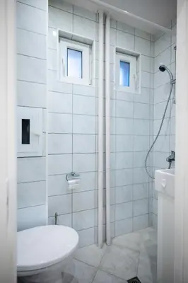 a white bathroom with a toilet and a sink at 1BD flat with Desk on Russian Monument Square by Flat Mаnager in Sofia