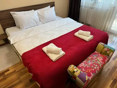 a bedroom with a large bed with two towels on it at Sunny & Comfort Apartment next to Tech Park for 4 Guests in Sofia