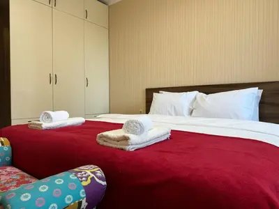 a bedroom with a large bed with towels on it at Sunny & Comfort Apartment next to Tech Park for 4 Guests in Sofia