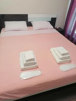 a bed with white towels on top of it at Sunshine terrace in Plovdiv
