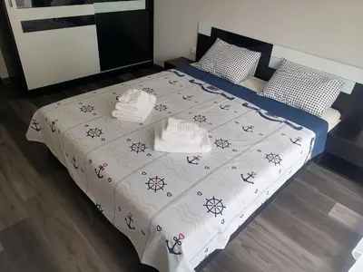a bedroom with a bed with towels on it at Sunshine terrace in Plovdiv