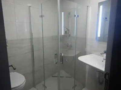a bathroom with a shower and a toilet and a sink at Sunshine terrace in Plovdiv